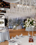 From Ceiling to Backdrop, Fringe String Curtains by ShopWildThings.com Can Do It All! Create a stunning backdrop or add a touch of magic to your ceiling. Choose from our ready-to-go colors or customize them to match your event perfectly. Need Fire Rated Decor? We offer FR String Curtains as Well!

White and Red Wedding Reception Decor with String Fringe Curtains Ceiling Decor