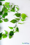 Detailed close-up of artificial silk ivy vine showing realistic layered green leaves with textured veins, perfect for weddings, parties, and interior decorating.