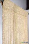 Angled close-up of gold metallic string curtain with sparkling strands and woven top header – ShopWildThings.com