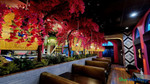 Bright fuchsia artificial bougainvillea branches layered on large-scale Sideswept Trees by ShopWildThings, forming a lush overhead canopy inside a trendy restaurant with bold interior styling and tropical-inspired textures