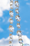 Crystal clear acrylic bead garland featuring two octagon bead sizes connected by jump rings, ideal for wedding reception decor, columns, and chandeliers from ShopWildThings.com