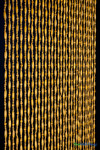 Side angle view of Sunnyvale Natural wood beaded curtain with 31 strands for doorways and room dividers from ShopWildThings.com