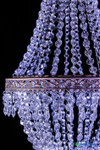 Medium empire-style acrylic crystal chandelier with cascading bead strands and ornate matte taupe metal trim for receptions and venue installations.