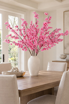 58-inch Super Premium Dark Pink Dogwood Branches arranged in a white vase on a dining table for upscale home and event decor – ShopWildThings.com