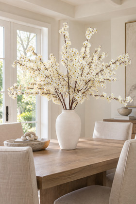 58-inch Super Premium Cream Dogwood Branches arranged in a white vase on a dining table for elegant home and event decor – ShopWildThings.com