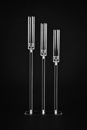 Timeless Luminosity: The "Solange" 3-Stem Acrylic Candelabra shown on black background with three clear tiered candle holders and mirrored base - ShopWildThings.com