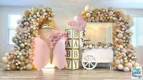 Artificial Flowering Trees by ShopWildThings.com are a fun way to add height, texture, and dimension to any party! Available in a wide range of colors, styles, and sizes from tabletop to sweeping archways. 

Pink and Gold Butterfly Baby Shower Decor Backdrop with Balloons