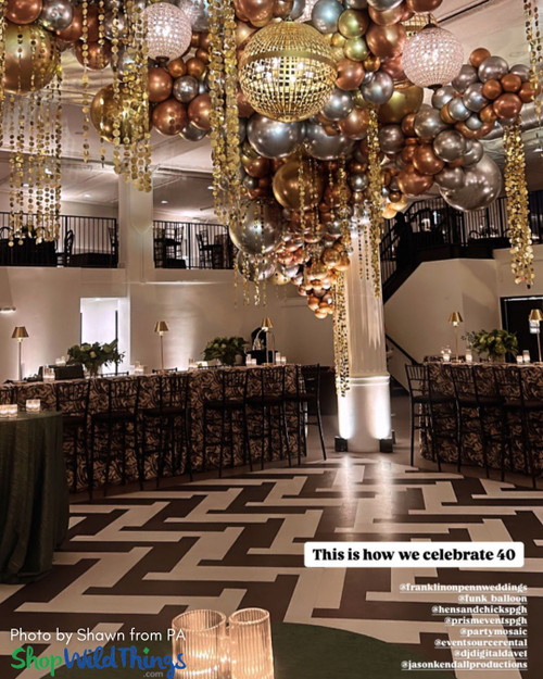 Mixed Metals Balloons and Curtains Ceiling Decor for 40th Party
ShopWildThings "Kate" Beaded Curtains added shimmer to this chic 40th birthday ceiling installation. These lightweight PVC curtains with metallic circles and crystal beads are easy to customize for any event. Available in silver or gold as full beaded curtains or columns, plus more metallic PVC styles to mix and match.
Glam Gold Silver Bronze Copper Black Dance Floor Decor