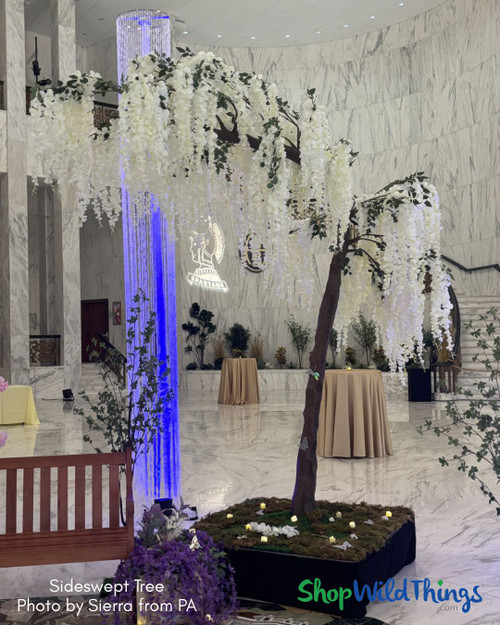White Wisteria Sideswept Tree for Elegant Event Decor
Looking for a dramatic yet elegant floral statement? This white wisteria Sideswept Tree from ShopWildThings delivers impact and flexibility. Swap out the branches with our Interchangeable Replacement Branch system for endless design options. Combine 2 and make an arch!