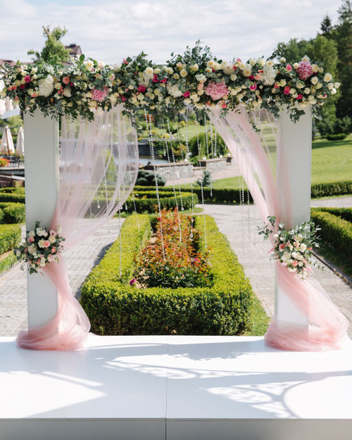 Create a Romantic Wedding Arch with Pink Flowers and Crystal Accents
Planning an outdoor wedding? Get inspired by this pink and white wedding arch, featuring artificial silk flowers, cascading greenery, and sparkling crystal accents- all available at ShopWildThings.com. Perfect for creating a dreamy ceremony backdrop!