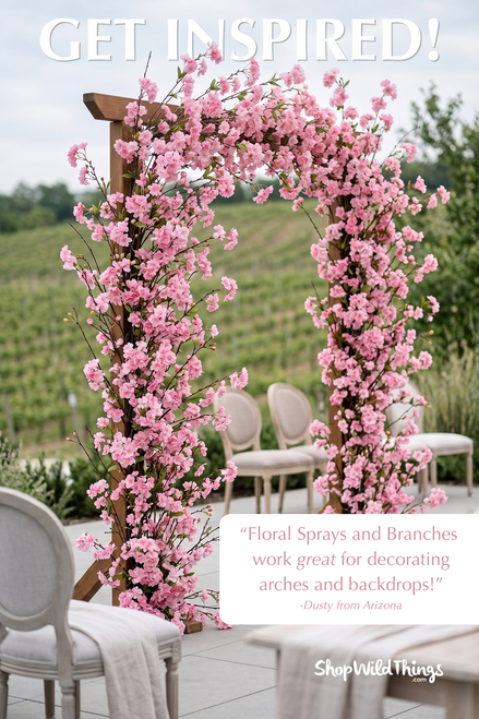 Faux plum blossom branches decorating wedding arch in outdoor vineyard venue with pink floral sprays – ShopWildThings.com