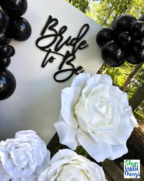 Bride to Be Backdrop with Black Balloons & White Jumbo Roses
Create striking black-and-white bridal decor with Jumbo Roses from ShopWildThings. This “Bride to Be” backdrop pairs cascading black balloons with oversized white roses for bold contrast—perfect for bridal showers, engagement parties, or bachelorettes. Shop 5 sizes and 11 colors (50+ roses in stock) to match any theme.