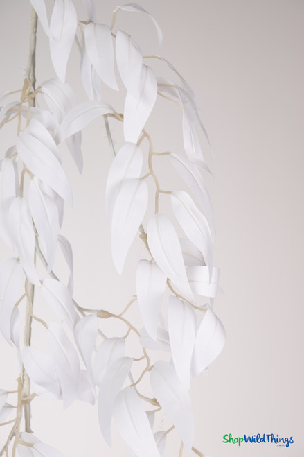 White artificial smilax garland with cascading leaves, photographed vertically to show realistic drape and lightweight vine design