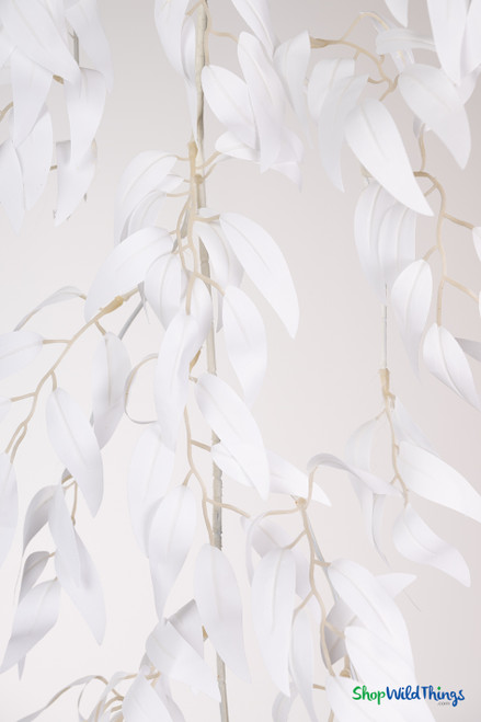 Detailed close-up of white artificial smilax willow leaves on flexible bendable wire vine for wedding and event décor