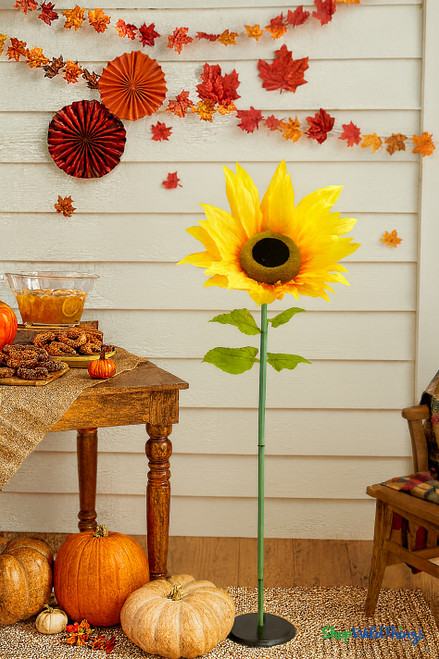 Oversized silk sunflower decoration 44 inches tall displayed at fall party with pumpkins, rustic table, and autumn garlands – perfect sunflower event prop from ShopWildThings.