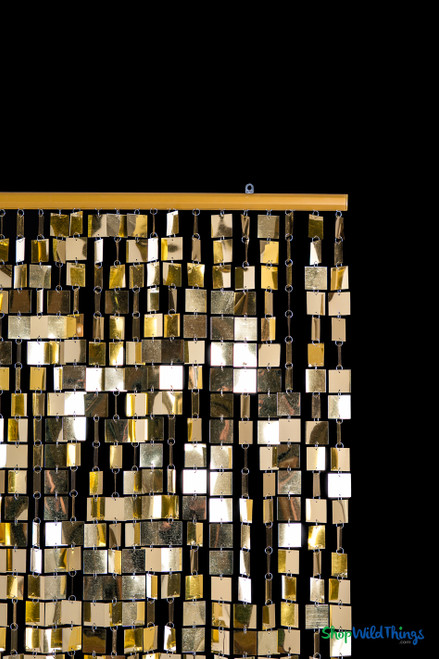 Close-up of the gold headrail and upper section of the Fabulous Gold Metallic Squares PVC Beaded Curtain showing square metallic PVC links connected with silver jump rings.