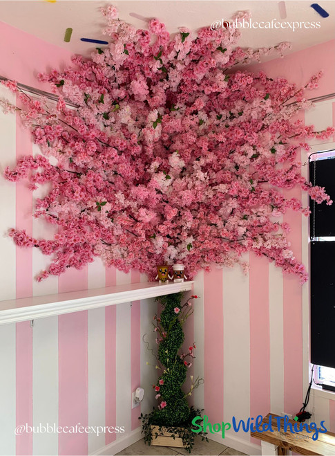 Layered Pink Cherry Blossom Install with ShopWildThings Floral Sprays
This stunning pink floral moment was created using layered cherry blossom sprays from ShopWildThings. Whether you're styling a café, retail space, or event backdrop, our faux florals make it easy to create custom, wow-worthy installations. Explore more at ShopWildThings.com.