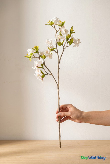 ShopWildThings artificial cherry blossom branch held in hand showing realistic 33 inch length and natural scale