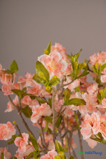 ShopWildThings artificial pink cherry blossom arrangement close-up showing soft blush blooms green leaves and realistic detail