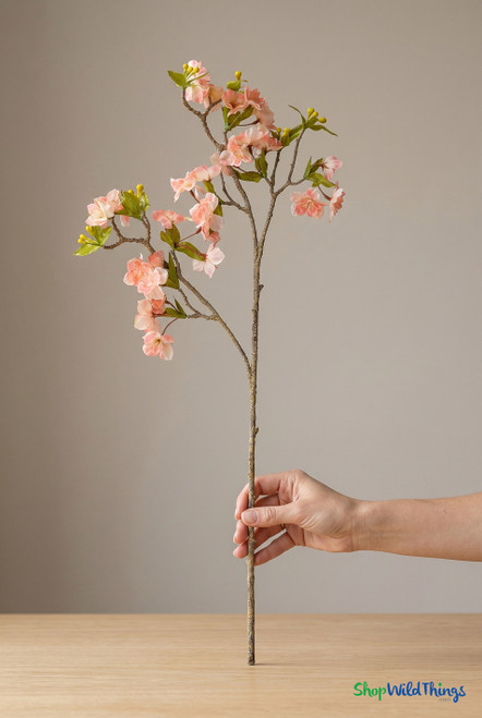 ShopWildThings artificial pink cherry blossom branch held in hand showing realistic 33 inch length and natural scale