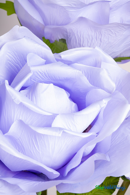 Close-up of oversized light purple artificial rose showing detailed silky petals, perfect for wedding photo props and event décor by ShopWildThings.com.