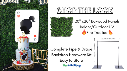 Create a “Queen of Hearts” inspired photo backdrop wall using FR Boxwood Greenery Panels and Oversized Jumbo Roses, and Professional Grade Pipe and Base, all available from ShopWildThings.com