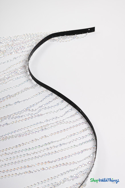 Straight-on wide shot of the full beaded curtain laid flat against a white background. Shows the uniform spacing of 56 strands and the even drape of each sparkling iridescent strand.