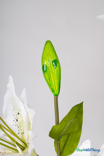 Close-up of ShopWildThings.com 46" Silk Oversized Lily unopened bud in bright green with realistic shape and texture, ideal for lifelike floral arrangements.