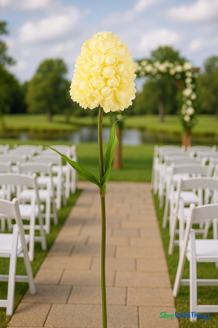 Oversized 65-inch tall by 17-inch wide artificial light yellow panicle hydrangea on long removable stem placed at an outdoor wedding venue.