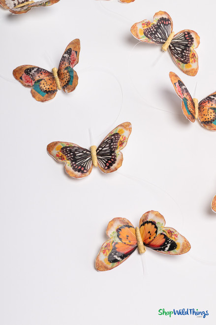 Handmade “Madrid” butterfly garland with orange, brown, and earth-tone feather butterflies strung on clear line, shown on white background.