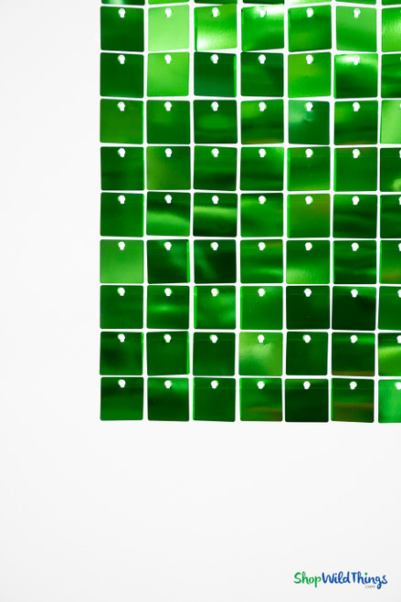 Emerald Green Shimmer Sequin Wall Panel close-up showing square reflective PVC spangles mounted on clear plastic grid backing – ShopWildThings shimmer backdrop panel