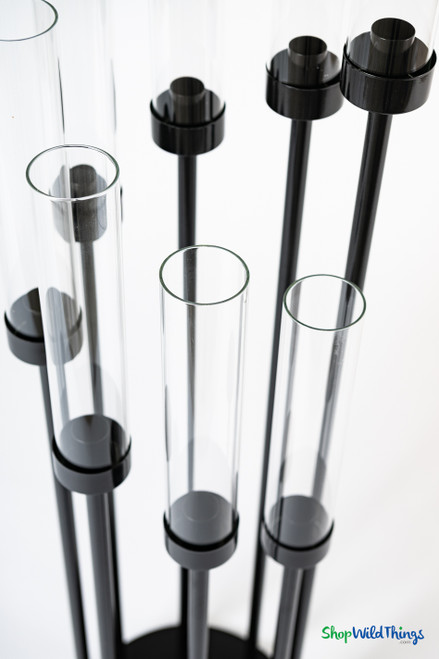 Detail view of clear glass hurricane cylinders and black candle cups on 8-arm black stem candelabra from ShopWildThings.com