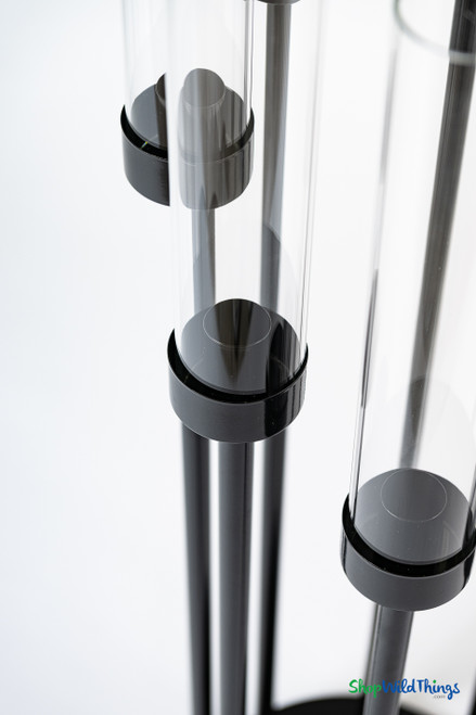 Close-up of black candle cups and clear glass hurricane shades on modern black tiered candelabra from ShopWildThings.com