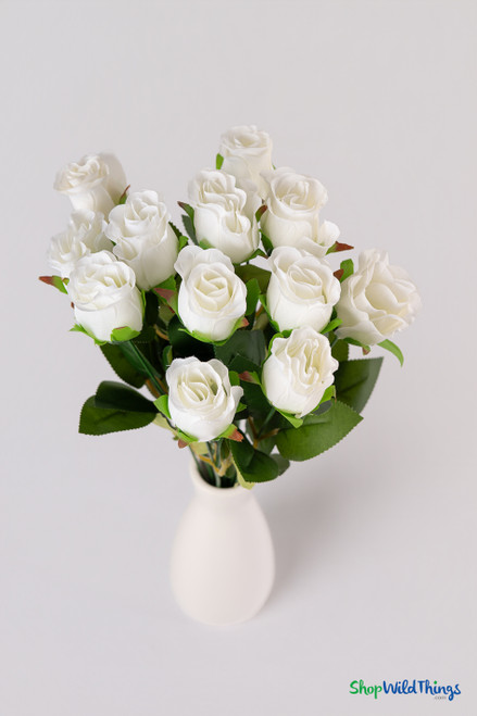 Ivory artificial rose bud bouquet displayed flat with 9" bendable stems and natural-looking greenery for event florals
