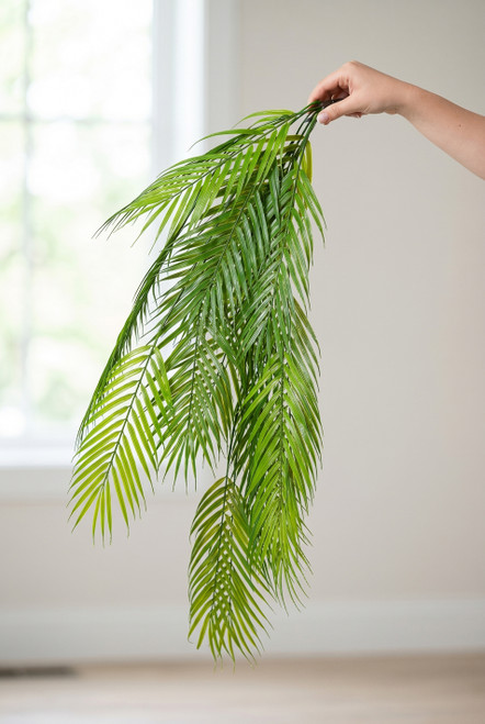 36" Artificial Hanging Palm Leaf Greenery from ShopWildThings.com held by a female hand to show realistic 36 inch cascading palm fronds
