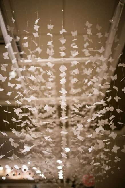 White Butterfly Garlands Suspended from a Ceiling as Event Decorations, ShopWildThings.com
