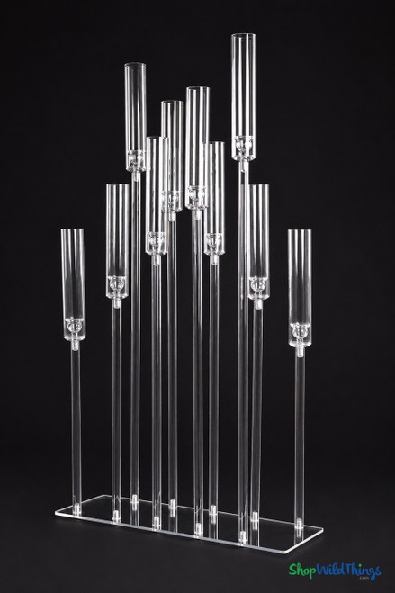 Isolde 10-stem staggered acrylic hurricane candelabra centerpiece with clear glass-look acrylic cylinders and customizable stem heights on a rectangular base for wedding and event table decor.