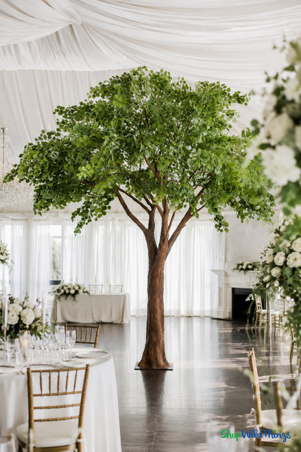Sylvie 12ft Premium Faux Eucalyptus Tree styled as a grand focal point inside an elegant wedding venue – ShopWildThings.com