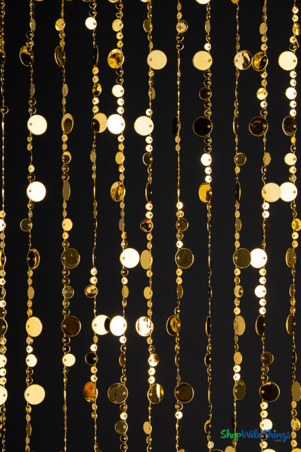 Detailed view of gold acrylic bubble beads in three sizes strung vertically, reflecting light beautifully for use as event backdrops, photo walls, or sparkling room dividers