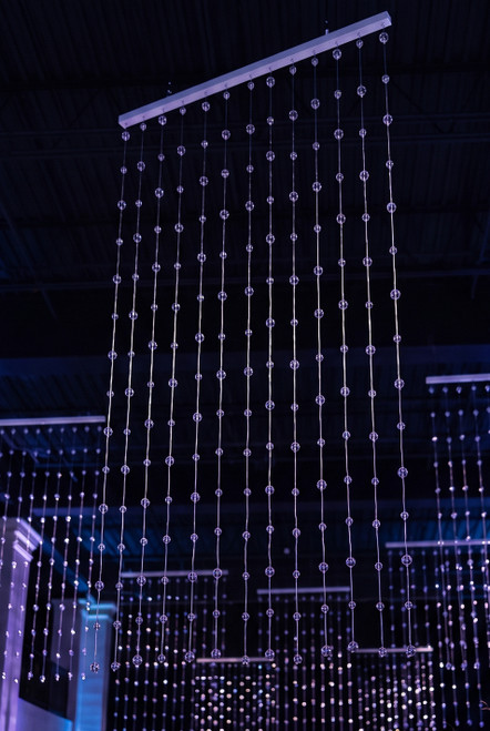 Clear Round Spheres Acrylic Ball Beaded Curtain 3' x 6' hanging in a blue-lit event venue for a sparkling ceiling installation – ShopWildThings.com