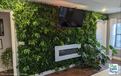 Imagine waking up to this view every morning! The blend of vibrant green foliage against the calming backdrop creates a statement wall that's simply enchanting. ?This incredible statement wall is decked out with 40" x 40" Paradise Greenery Wall Panels by ShopWildThings.com! These indoor/outdoor UV Artificial Greenery Panels make it easy to get that jungle bedroom look or that zen spot in the backyard.