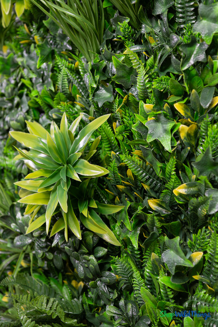 Close up of high density artificial greenery wall mat showing realistic ferns ivy grasses and layered foliage textures – 2" to 7" depth – FR Class C fire treated backdrop panel