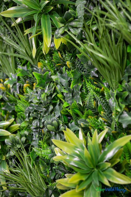 Close up of high density artificial greenery wall mat showing realistic ferns ivy grasses and layered foliage textures – 2" to 7" depth – FR Class C fire treated backdrop panel