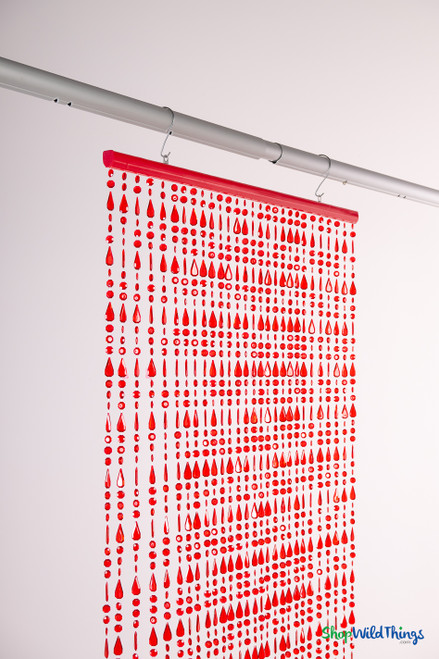 Angled view of red crystal beaded curtain hanging from hooks, showing 28 strands of alternating diamond and teardrop beads