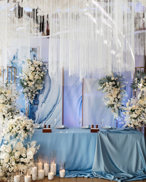 From Ceiling to Backdrop, Fringe String Curtains by ShopWildThings.com Can Do It All! Create a stunning backdrop or add a touch of magic to your ceiling. Choose from our ready-to-go colors or customize them to match your event perfectly. Need Fire Rated Decor? We offer FR String Curtains as Well!

Blue White and Gold Wedding Reception with String Fringe Curtain Ceiling Decor