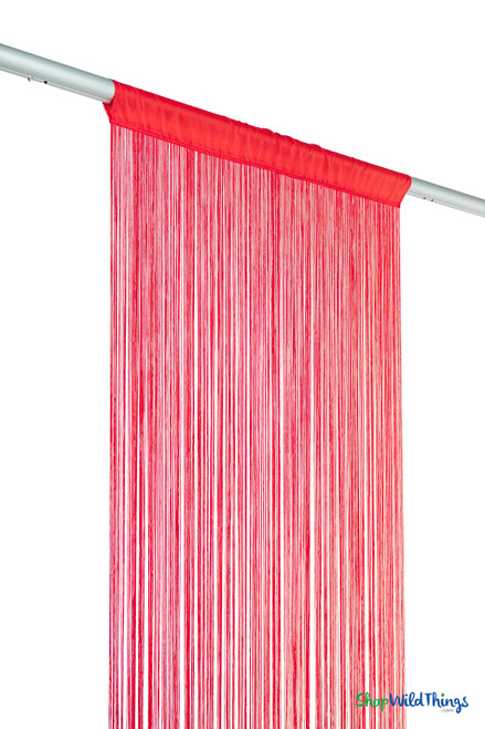 Side-angle view of red fire-rated string curtain on hanging rod showing the full 20-foot length and flowy texture — ShopWildThings decorative fringe panel.