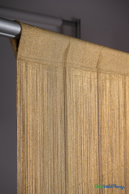 Angled close-up of gold metallic string curtain with sparkling strands and woven top header – ShopWildThings.com