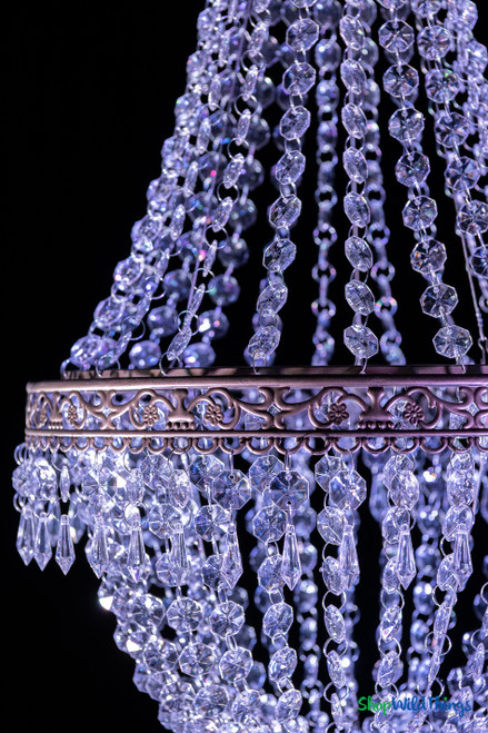 Medium empire-style acrylic crystal chandelier with cascading bead strands and ornate matte taupe metal trim for receptions and venue installations.