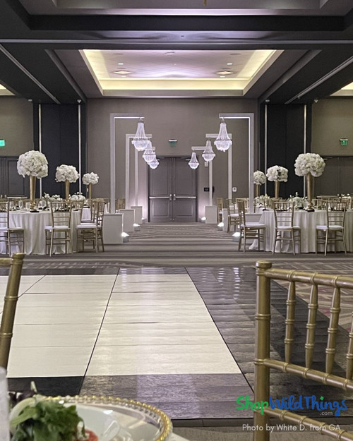 Elegant White and Gold Wedding Reception Decor with Crystal Chandeliers
Create a breathtaking white and gold wedding reception entrance with stunning crystal chandeliers from ShopWildThings. This elegant entrance features Tillie acrylic beaded chandeliers in multiple sizes, adding dimension and glamour to the ballroom.   Elevate your wedding decor with timeless sophistication and luxurious lighting.