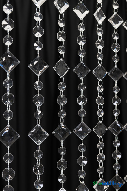 Detail of 12 foot professional crystal bead curtain with diagonal square beads and faceted pendant drops reflecting stage lighting